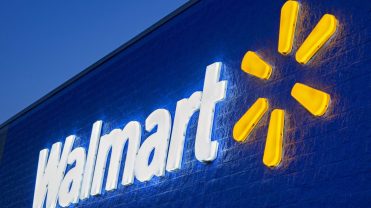 The header image shows a photograph of a lit up Walmart sign.