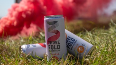 The header image shows a few cans of Three Fold hard seltzer.