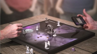 Photograph of people sitting around playing chess on a digital game board.
