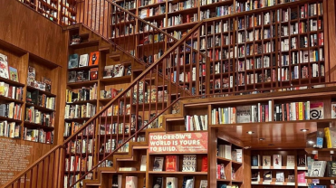 Photograph inside a large two story bookstore filled from floor to ceiling with books.