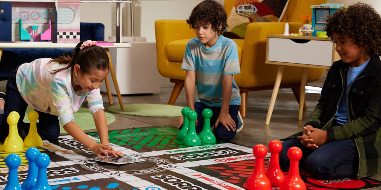 Photograph of children playing a large board game.
