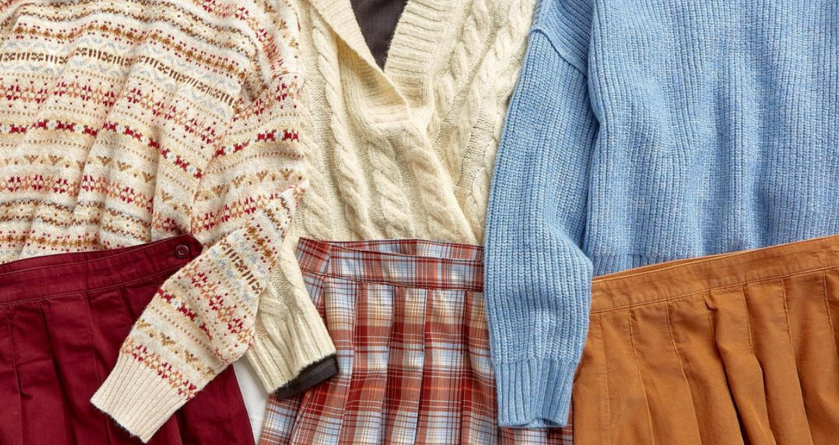 Red, white, and blue sweaters laid out with red, plaid and orange skirts