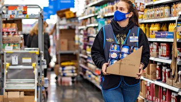 Walmart employee stocking shelves