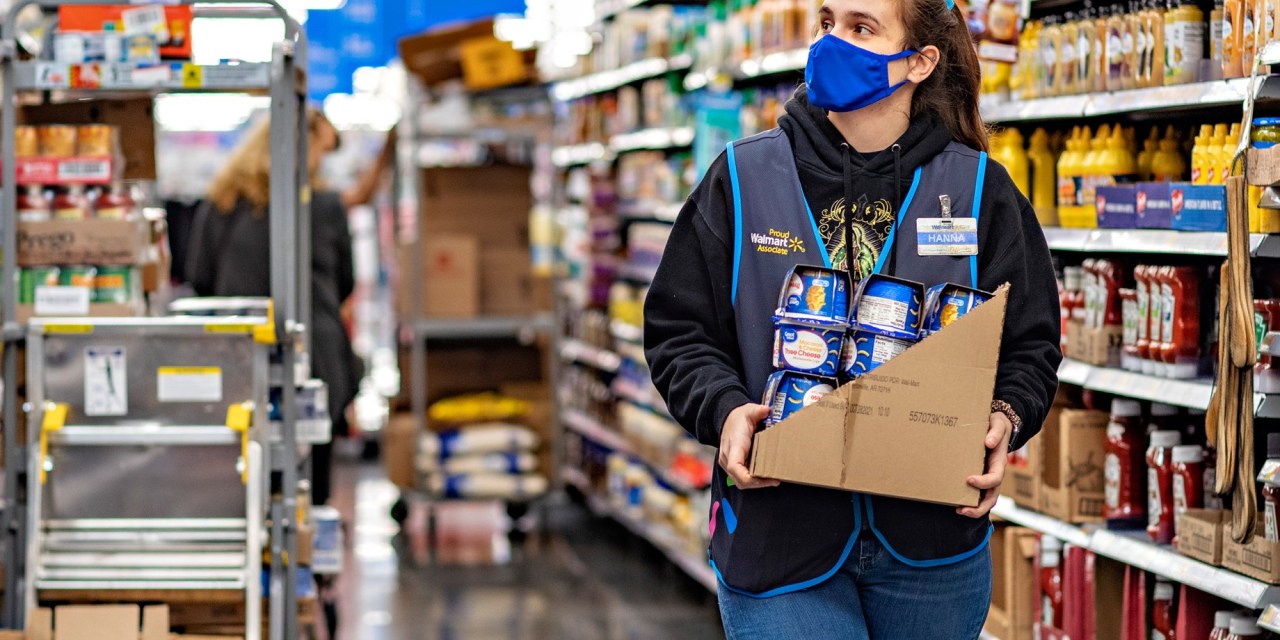 Walmart employee stocking shelves