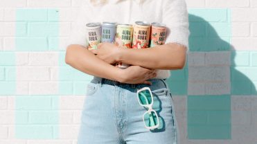 Person holds five cans of different Aura Bora sparkling water flavors