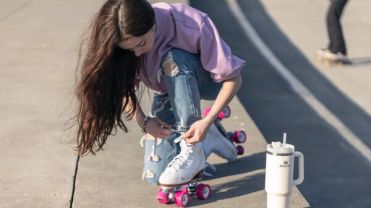 Roller skater poses next to Stanley product