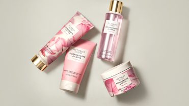 Victoria's secret beauty items on a tan background