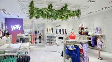 Clothing store with sports bras, leggings, and other women's athleticwear displayed throughout the store