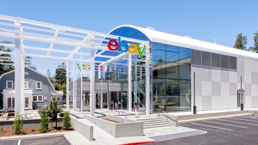 A glass building glistens in the sun at eBay's San Jose, California headquarters