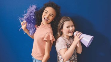 Two young girls dressed in Evsie products