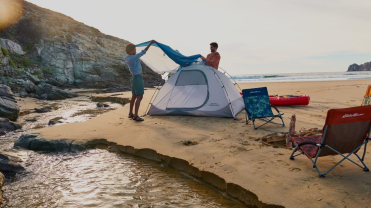 Two guys try to set up a tent