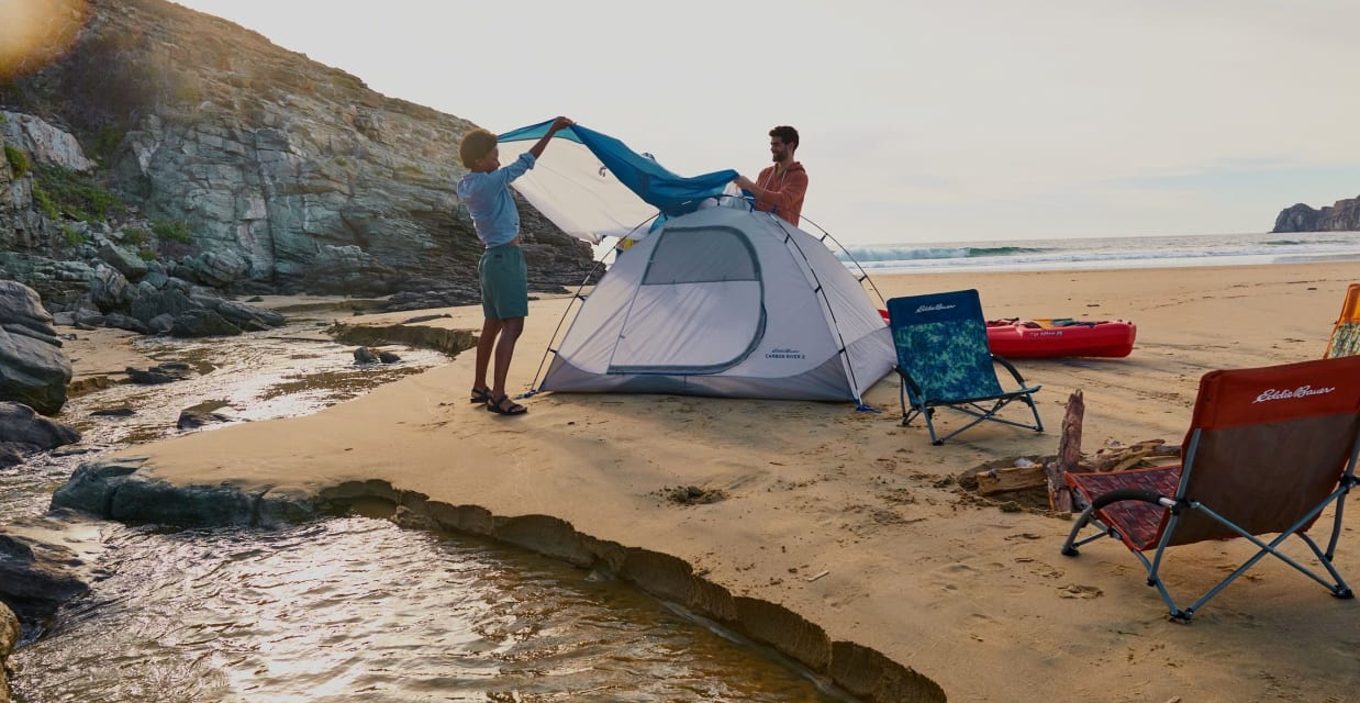 Two guys try to set up a tent