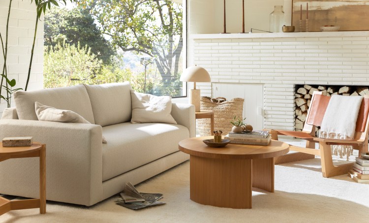 A living room with the new Parachute sofa, coffee table, chair and end table