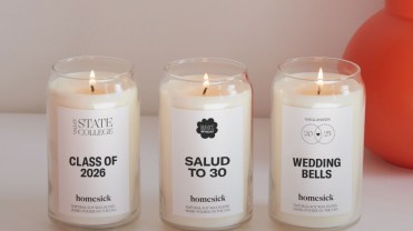 Custom Homesick candles in glass jars on a white tabletop