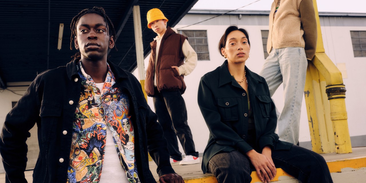 Models pose outside near an underpass wearing denim