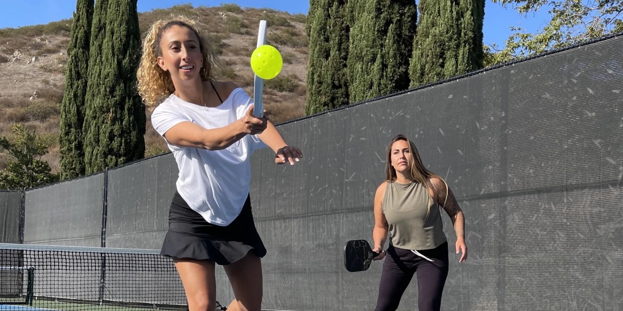 Two athletes play pickleball in Civile Apparel clothing