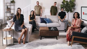 Six people positioned around a living room set with a TV that says "overstock.com"