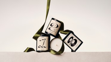 Prose candles with white labels and black text, adorned with green ribbons