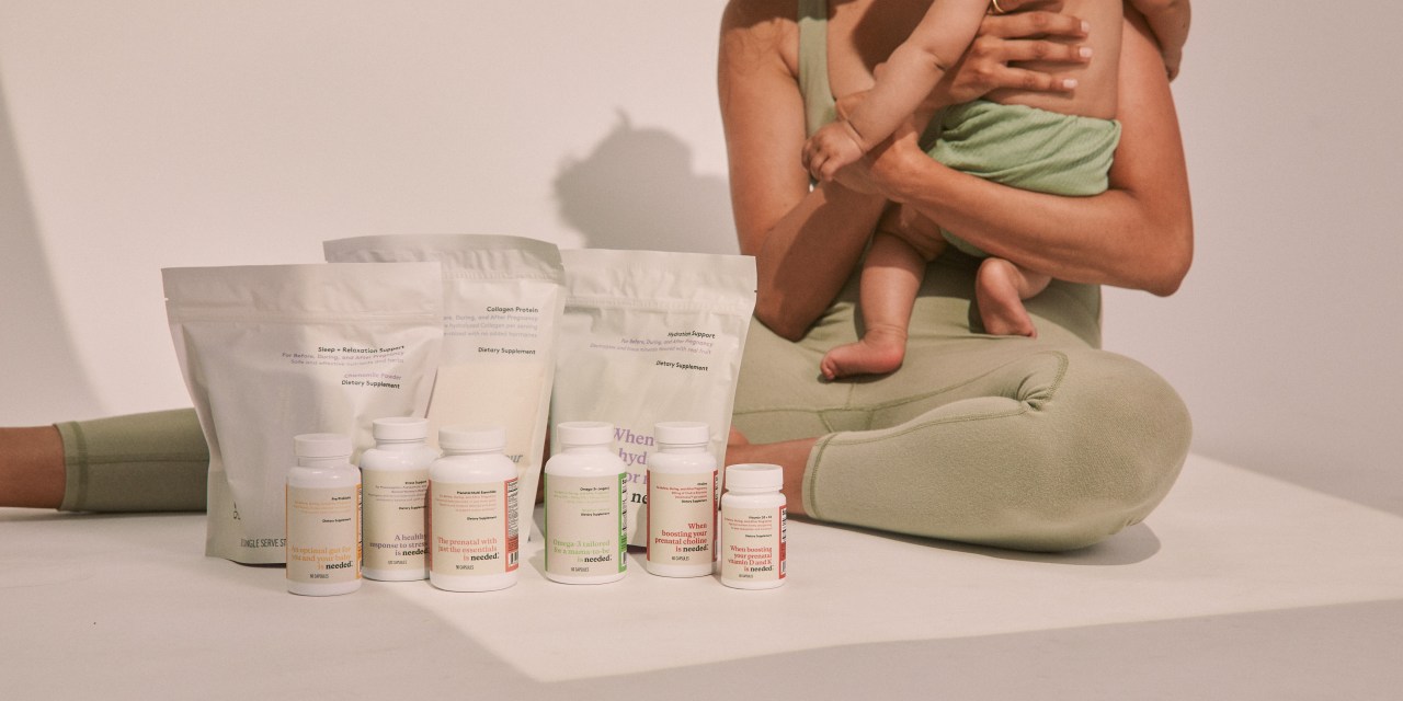 Needed's prenatal vitamin assortment with a mother and child in the background.
