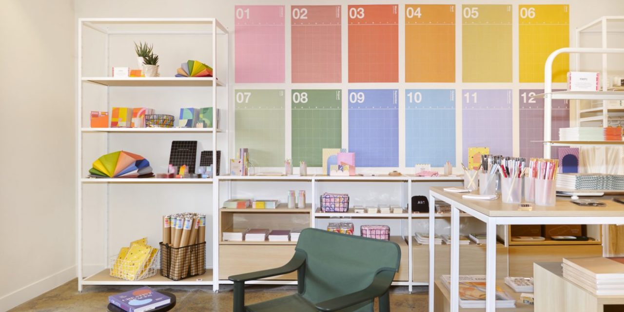 A colorful display of stationary and housewares in a well-lit retail environment.