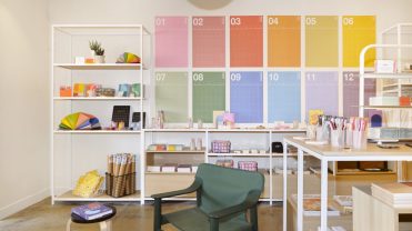 A colorful display of stationary and housewares in a well-lit retail environment.