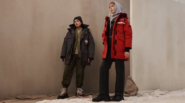 Two models wearing black and red Canada Goose jackets.