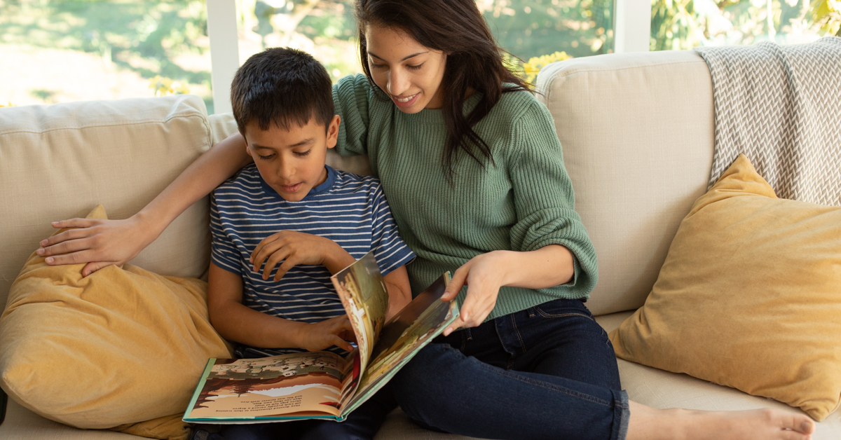 A mother and child reading a book.