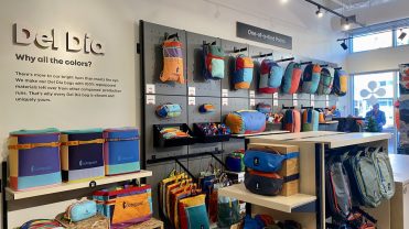 A wall of backpacks from Cotopaxi at its Denver store.