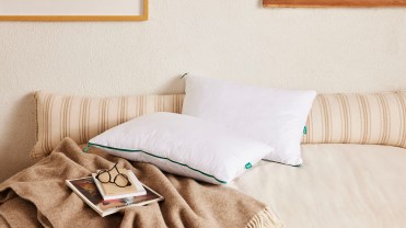 Marlow's pillows on a beige bed.
