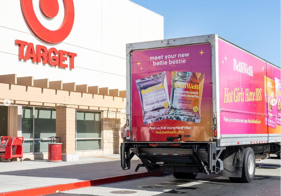 A pink BelliWelli truck in front of a Target.