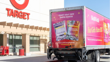 A pink BelliWelli truck in front of a Target.
