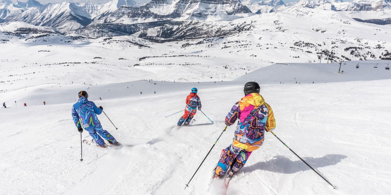 People skiing down a snowy mountain.