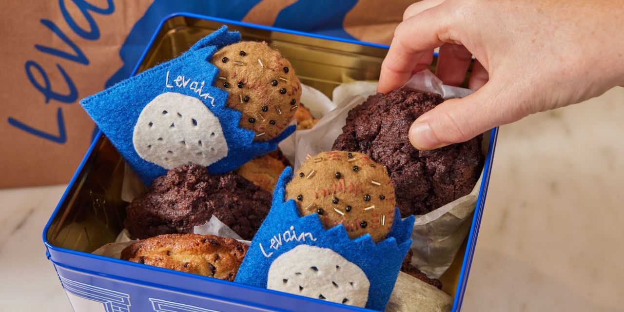 Levain cookies and ornaments in a tin box.