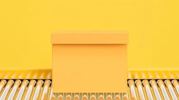 Yellow box on an assembly line, sitting on a yellow background