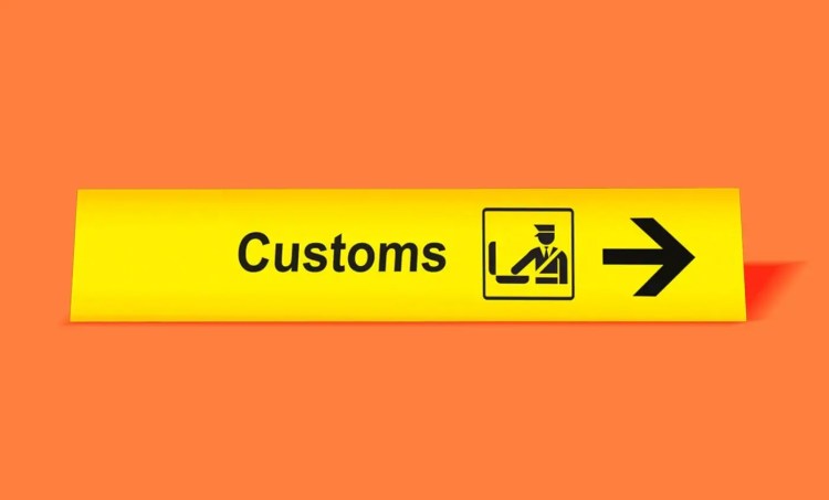 Bright yellow "customs" sign on an orange background.
