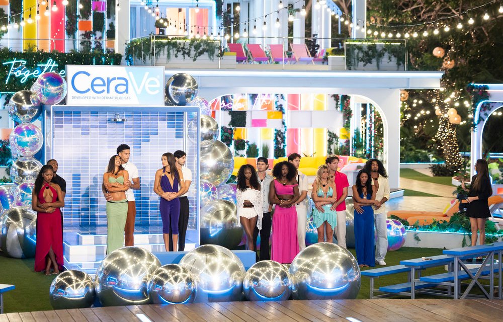 Love Island contestants stand in front of a "CeraVe" display with disco balls on the floor.